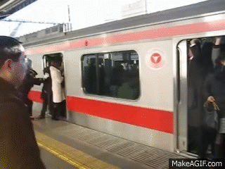 People stuffed onto a train in Tokyo, Japan (train stuffing Tokyo) on