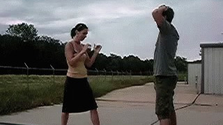 Woman kicking man in the balls