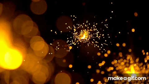 Three Orange Sparklers Against Dark Background Video Effects On Make A Gif