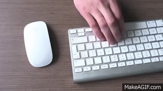 Website designer is using wireless mouse and wireless keyboard at the  office desk. Free HD video on Make a GIF