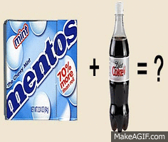Close-up of Mentos dropping into a bottle of Coke causing an immediate reaction