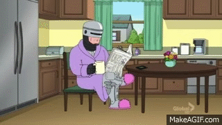 2 second gif of robocop wearing pink bathrobe and fuzzy slippers reading newspaper and drinking coffee in the kitchen from the family guy tv show