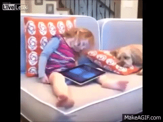Dog wakes up little girl on couch